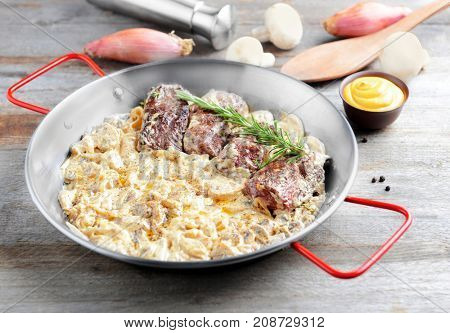Dish with steak Diane on table