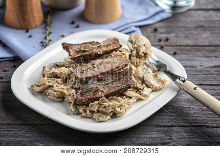 Plate with steak Diane on table
