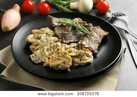 Plate with steak Diane on table