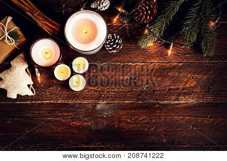 Christmas candle and rustic decoration on wood table with christmas lights in night party. copy space flat lay top view. vintage color style.