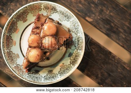 top view of a piece of sweet macademia cookies cake, delicious sweet dessert with beautiful dish