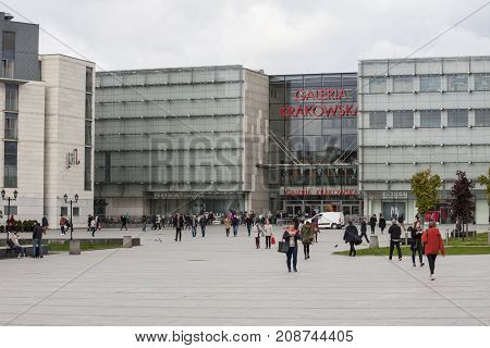 Galeria Krakowska shopping centre main square Cracow Poland - October 13 2017: People walking through Galeria Krakowska shopping centre main square repair crew is fixing a square water outflow Cracow Poland.