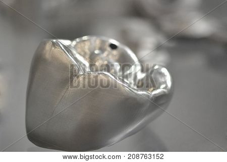 Object printed on metal 3d printer. A model created in a laser sintering machine close-up. DMLS SLM SLS technology. Concept of 4.0 industrial revolution. Progressive modern additive technology.