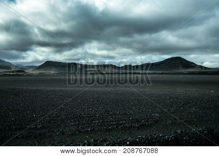 Lunar landscape of Iceland endless volcanic areas and mountains in the background.