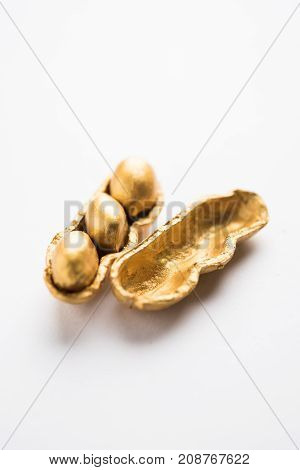 Concept of individuality, luck,value,exclusivity and better choice. Golden peanut or ground nut, standing out amongst normal peanuts, over black or white background
Concept of individuality, luck,value,exclusivity and better choice. Golden peanut or groun