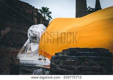 Ayutthaya Thailand - October 13 2017: Old anceint buddha statue with yellow robe sleep at Wat Yai Chaimongkol Ayutthaya Thailand.