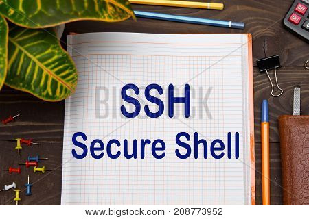 Notebook with a notes SSH on the office table with tools. Business concept