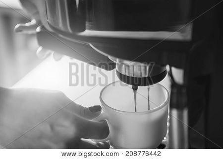 Woman Making Fresh Espresso In Coffee Maker. Coffee Machine Makes Coffee.