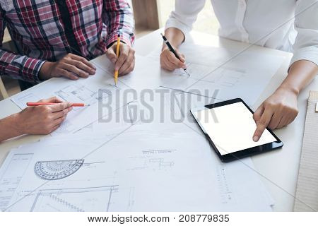 Architect working on blueprint Engineer meeting working with partner colleagues and engineering tools for architectural project Construction concept.