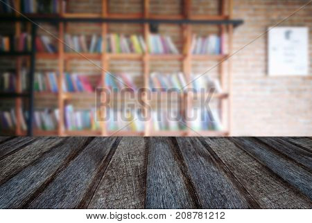 Empty wooden table and blur background of abstract in front of modern library or knowledge source can be used Mock up for display of product or for montage.