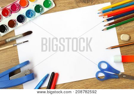 Blank sheet of paper with colorful artist instruments creative process