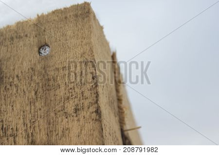 A detail wooden beam with a nail