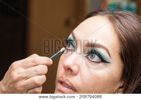 Makeup Artist Cleaning And Giving The Final Touches To Cat Eyes Makeup