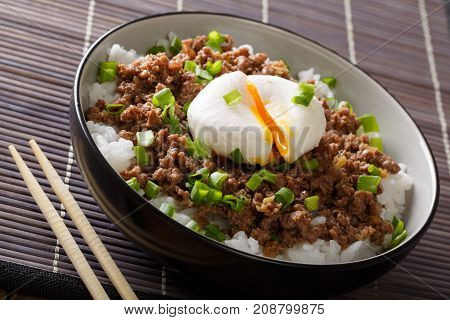 Japanese Dish: Spicy Meat Soboro With Egg Poached And Rice Close-up In A Bowl. Horizontal