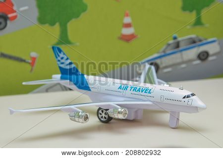 White airplane toys in the background without focus Plastic toy plane on blue copy space background for travel concept