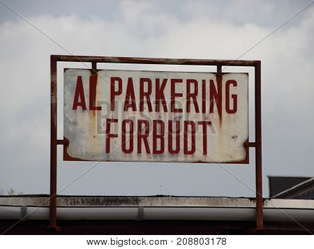 Rusty Old Danish No Parking Sign with Plastic Gutter Closeup