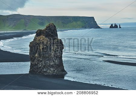 Rocks and clifs on Kirkjufjara black sand beach, southern Iceland.