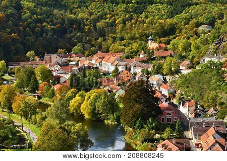 Vranov nad Dyji (Vranov above Thaya) Beautiful autumn landscape with river, castle, blue sky with clouds and sun. Czech Republic.