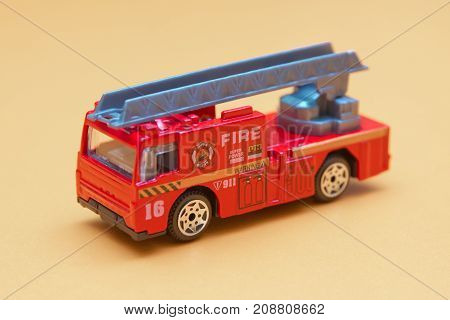 Red toy fire truck Toy fire engine extinguishes flaming house. Careless handling of fire dangerous for life