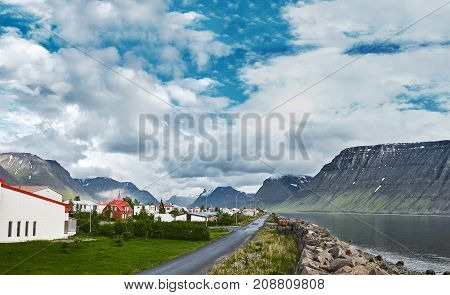 Travel to Iceland. beautiful cloudy sky over fjord and Flateyri, a village in the north-west of Iceland, on the Westfirdir peninsula in Iceland.