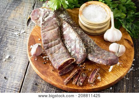 Beef Jerky Smoked Sausage Sudzhuk With Spices And Garlic Is Served On A Cutting Board. Copy Space Fo