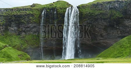 famous Seljalandsfoss waterfall in southern Iceland. treking in Iceland. Travel and landscape photography concept