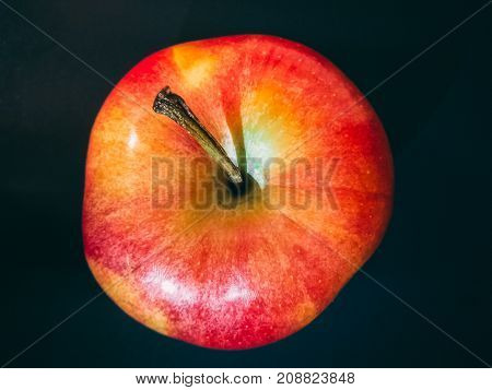 Delicious apple seen from above on black background