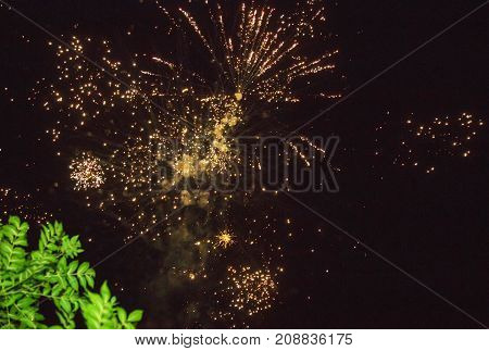 A photo of a salute in the night sky. Bright texture of festive fireworks. Abstract holiday background with various colors fireworks light. New Year's