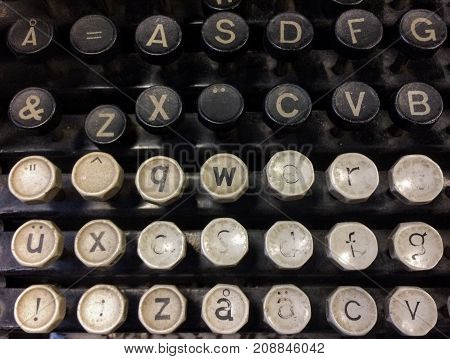 Finnish grungy old vintage typewriter including uppercase and lowercase letter A with ring, letters A and U with diaeresis, combining diaeresis, QWERTY, and ASDF keys.