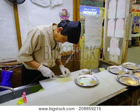 Chef In Uniform Preparing Sushi And Sashimi