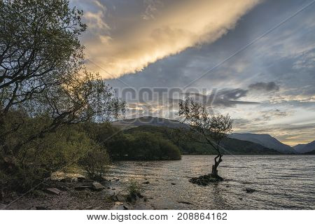 Beautiful Landscape Image Of Llyn Padarn At Sunrise In Autumn In Snowfonia National Park