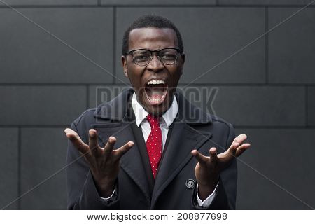 Urban Closeup Of Handsome African Male Standing Isolated Against Grey Wall Wearing Formal Clothes An