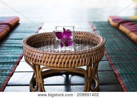 Orchid Flower In Glass. Thai Backrest Pillow On Mat. Thailand Scatter Cushion Mattress For Spa Massa