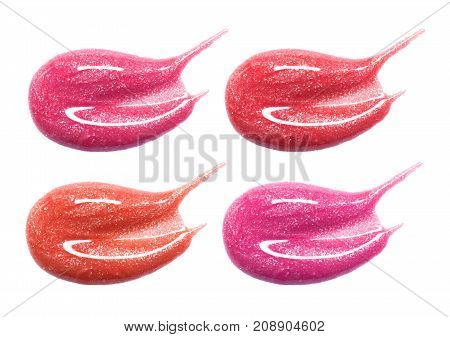Set of different lip glosses pastel color smear samples isolated on white. Smudged makeup product sample.