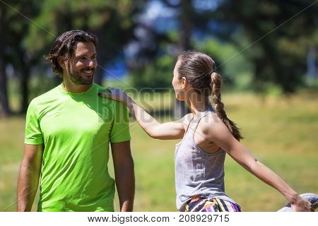Smiling Couple Stretching Outdoors