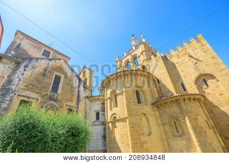 Behind the Old Coimbra Cathedral in a sunny day. Se Velha de Coimbra, is one of most important romanesque buildings in Portugal and landmark in university center town of Coimbra, north of Portugal.