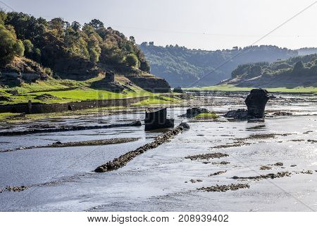 Stones and ruins on the bottom of a dry reservoir in Portomarin Northern Spain.