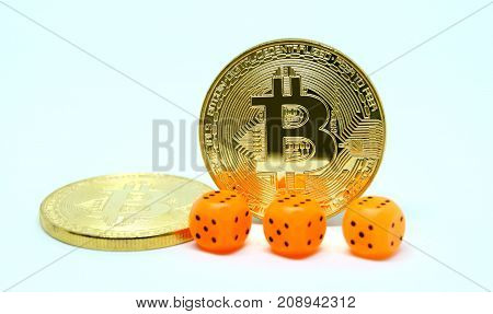 Three dice and two coin of bitcoin. Risks of invest to bitcoin. Fluctuations the rate of bitcion on market.