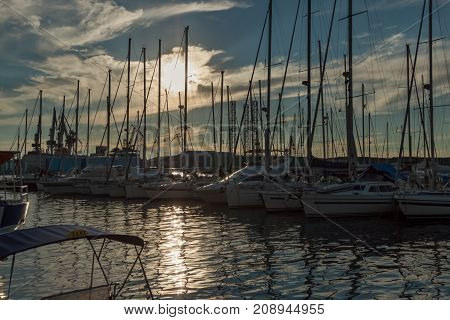 Boats in marina on a sunny day with some clouds