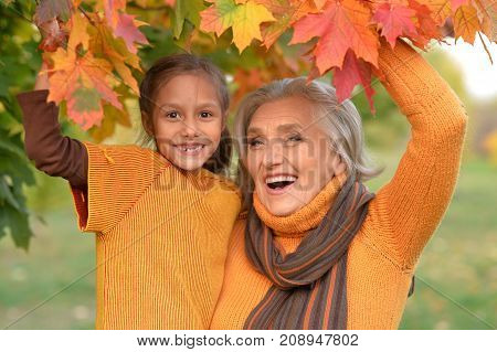 granny and granddaughter posing outdoors in autumn part