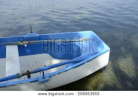 Rustic blue boat on lake of Banyoles Girona in northeastern Catalonia Spain.