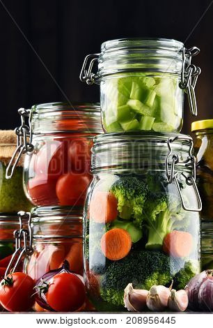 Jars With Marinated Food And Organic Raw Vegetables