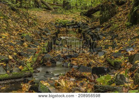 Stone trough near Chribska Kamenice river in national park Ceske Svycarsko in autumn morning