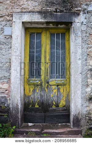 An old door in an abandoned building in the hill village of Casso in Friuli Venezia Giulia north east Italy. With a population now of only 35 the village is famous locally for having being evacuated following the 1963 Vajont Dam disaster.