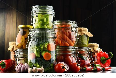 Jars With Marinated Food And Organic Raw Vegetables