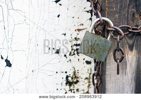 Old Closed lock on the chain. Water droplets are visible on the lock