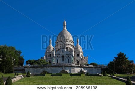The basilica Sacre Coeur is a Roman catholic church located at the summet of the butte Montmartre , the highest point in Paris.