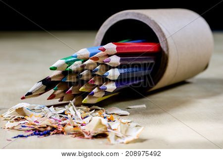 Crayons And Pencil Sharpener On A Wooden Office Table. Crayons With Sharpening Crayons And Pencils O