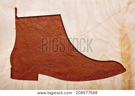 Silhoutte Of Leather Chelsea Boots In The Center.top View.wooden Background.concet Shoes Shop