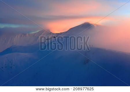 Unbelievable evening on the snowy hill from the life of free- rider. The mountains are in snow. Unbelievable winter landscape.